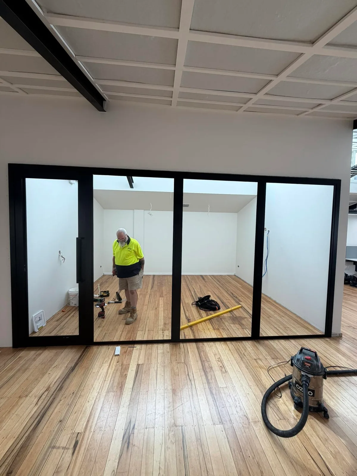 Peter Rosser laying new timber flooring on an Auckland renovation